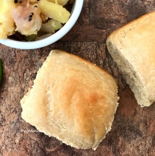 A cut in half sandwich sitting on top of a piece of bread