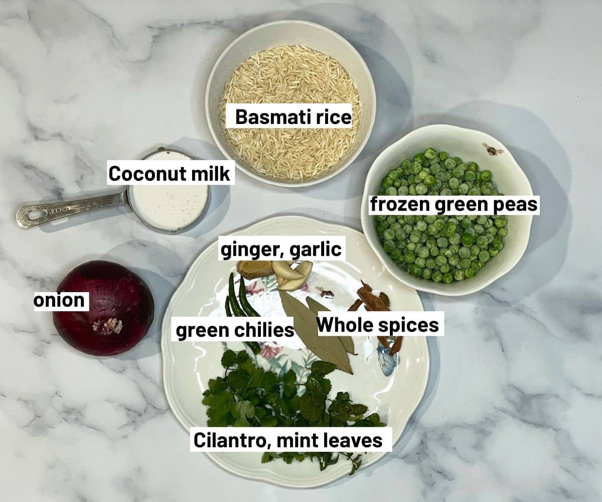 All the ingredients for Matar pulao are placed on the marble table.