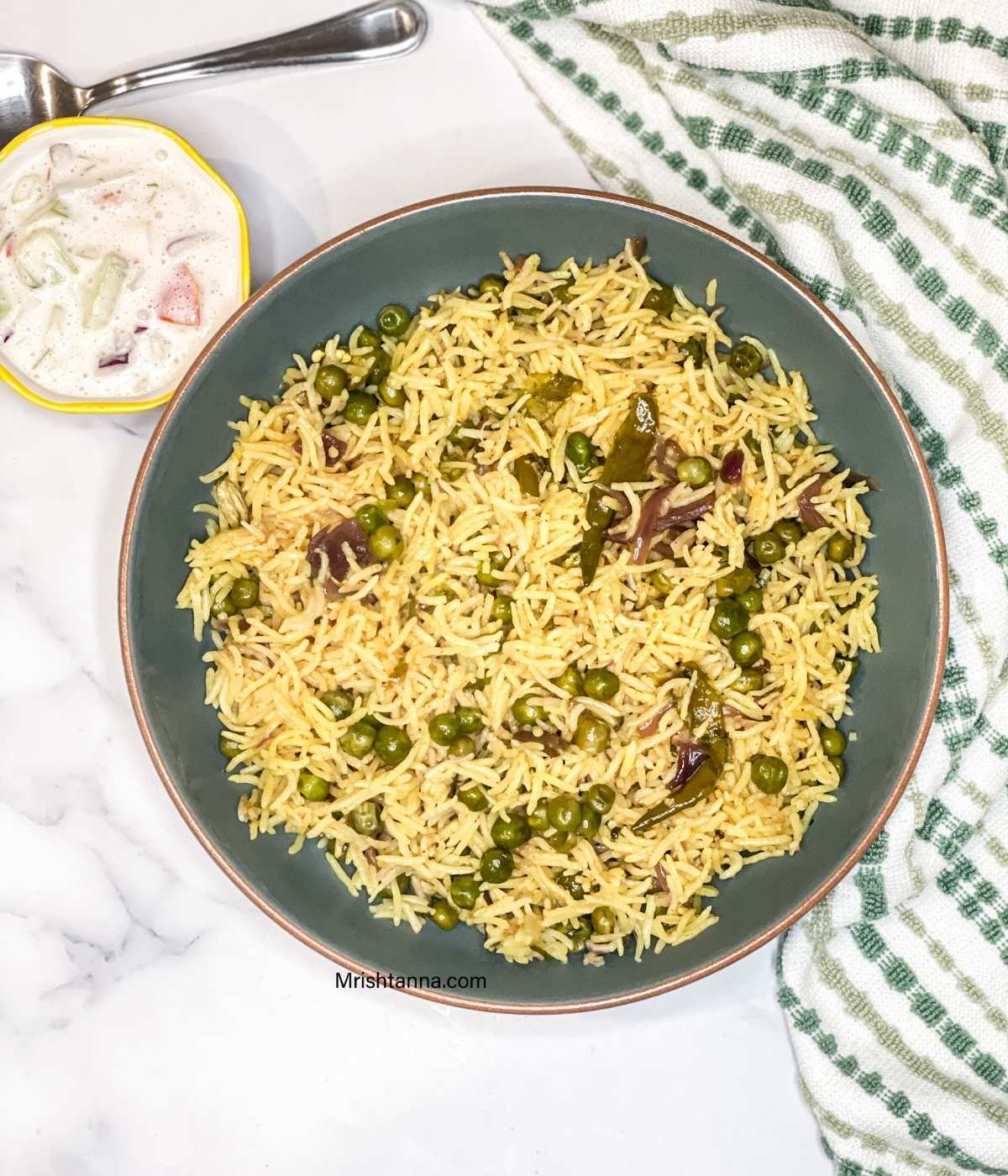 Instant Pot peas pulao made with basmati rice and green peas, served with vegan raita.