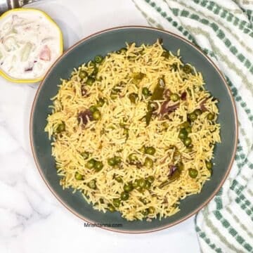 Instant Pot peas pulao made with basmati rice and green peas, served with vegan raita.