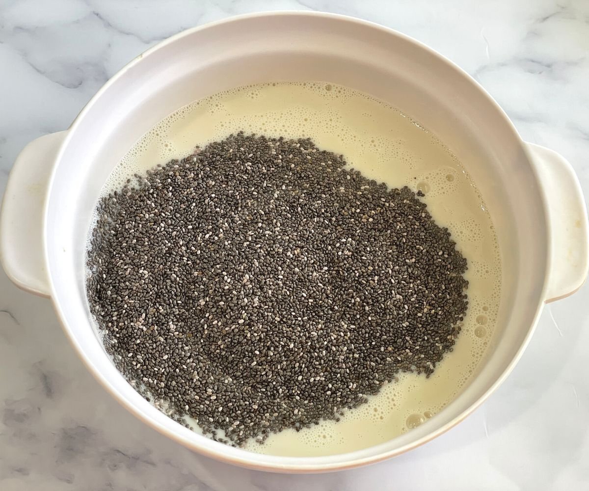 A bowl is with oat milk and chia seeds. 