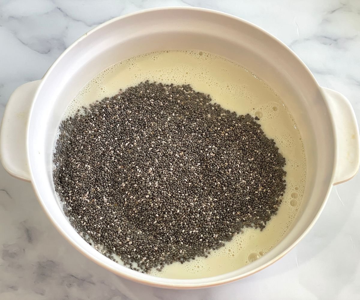 A bowl is with oat milk and chia seeds.