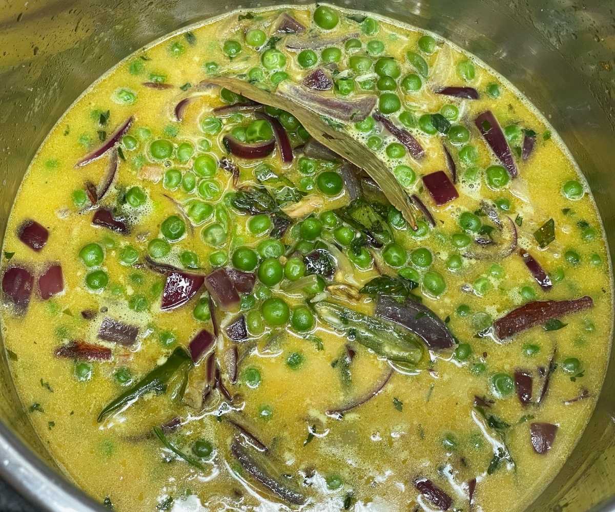 An instant pot is with Matar rice.