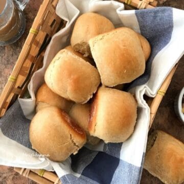 A tray is filled with wheat pav rolls.