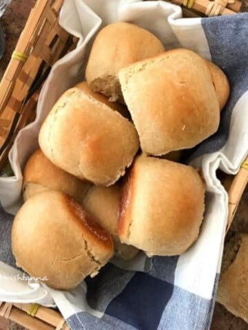 A tray is filled with wheat pav rolls.