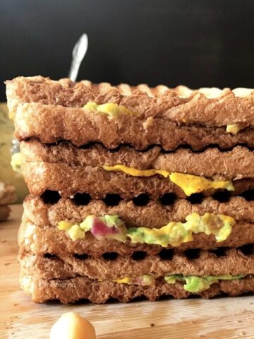 Sandwich stacked on top of a wooden table