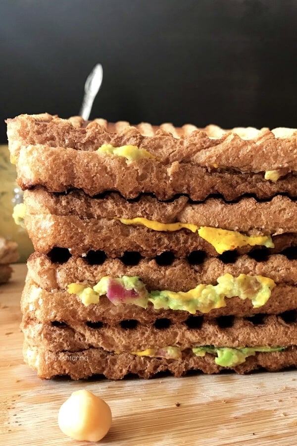 Sandwich stacked on top of a wooden table