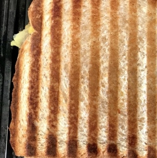 A close up of food on a table, with Avocado and Panini