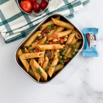 A lunch box is filled with masala pasta.