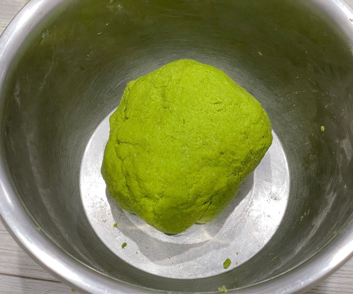 A bowl is with spinach paratha dough.