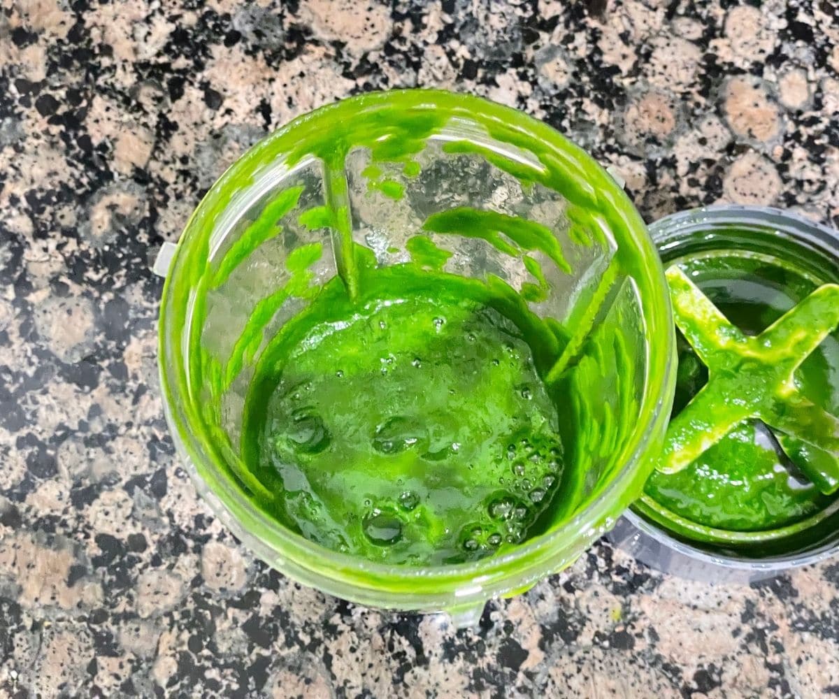a blender is with spinach puree.