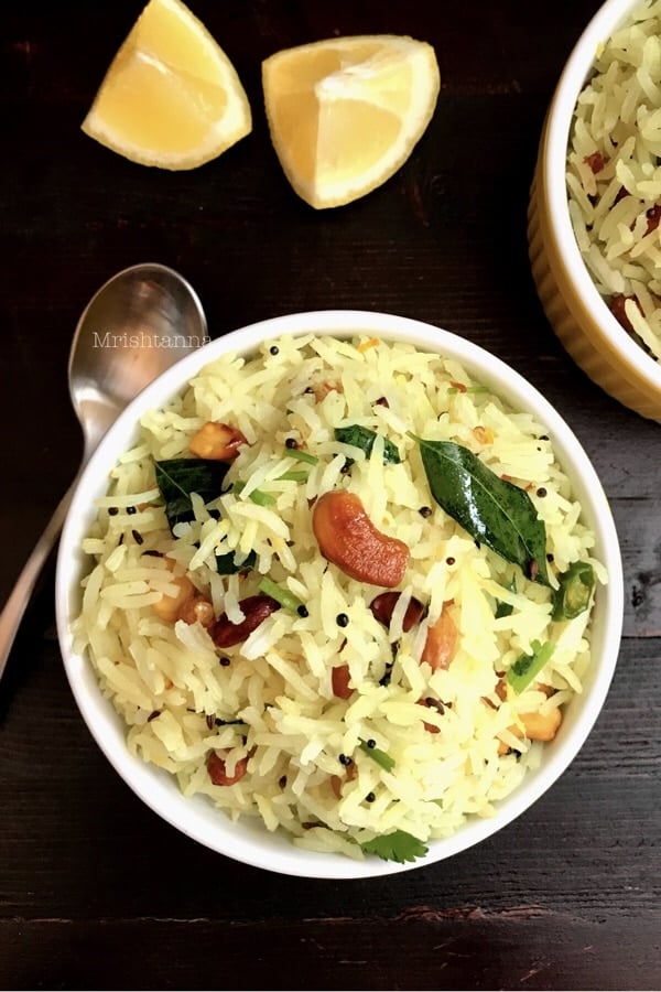 A bowl of lemon rice and topped with nuts