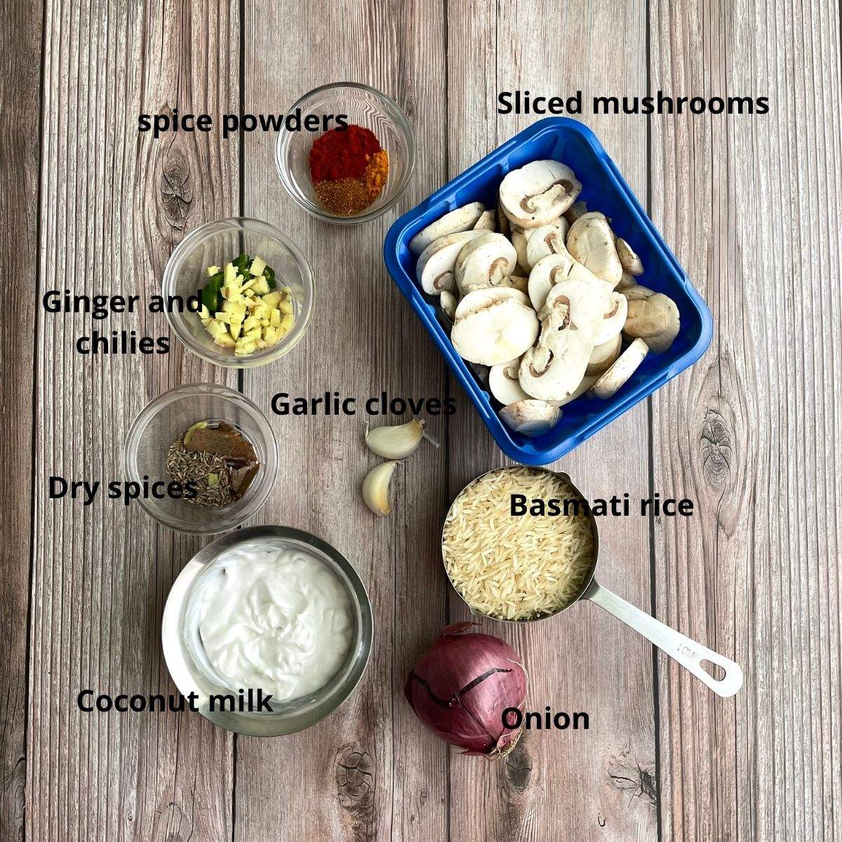 All the ingredients for mushroom rice is on the table like mushrooms, rice, spices and coconut milk.