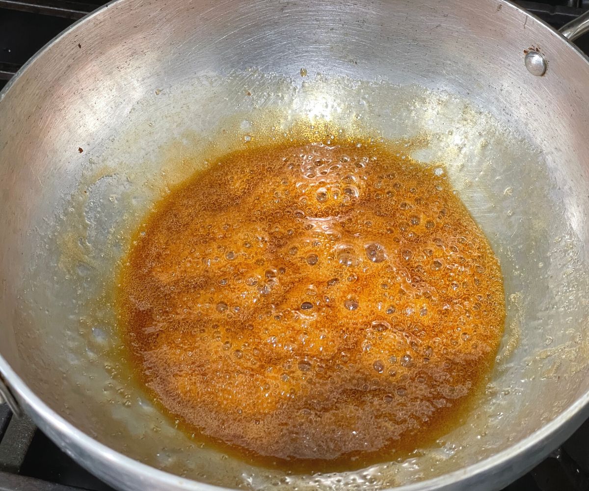 A big pot is with jaggery syrup over the heat.