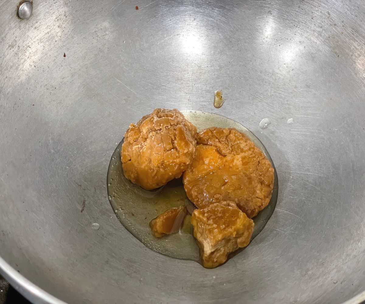 A big pot is with jaggery and water over the heat.