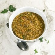 A bowl is with green gram dal is on the table