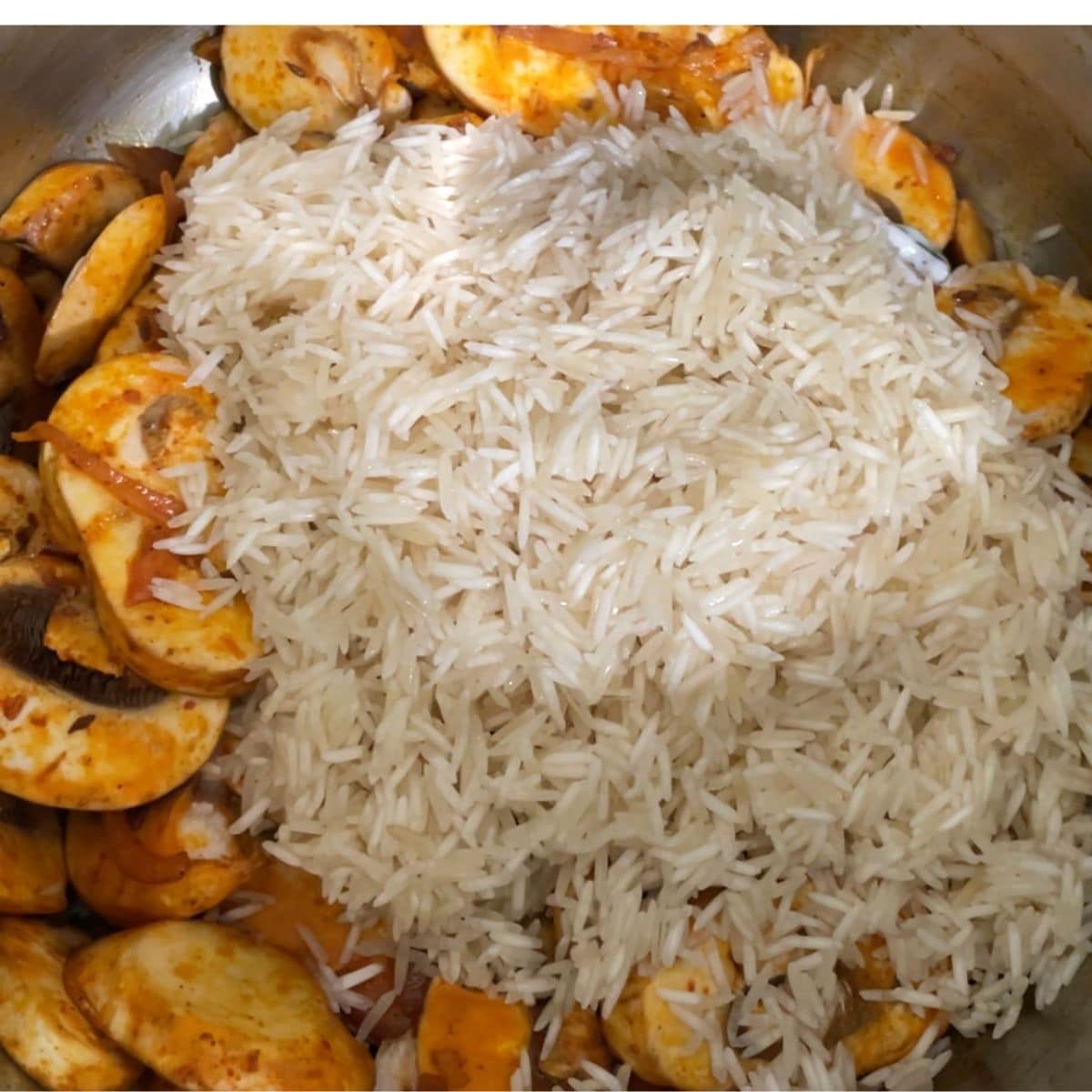 A pot filled with rice and mushrooms