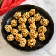 A plate of peanut jaggery ladoo is on the table.