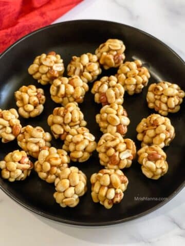 A plate of peanut jaggery ladoo is on the table.