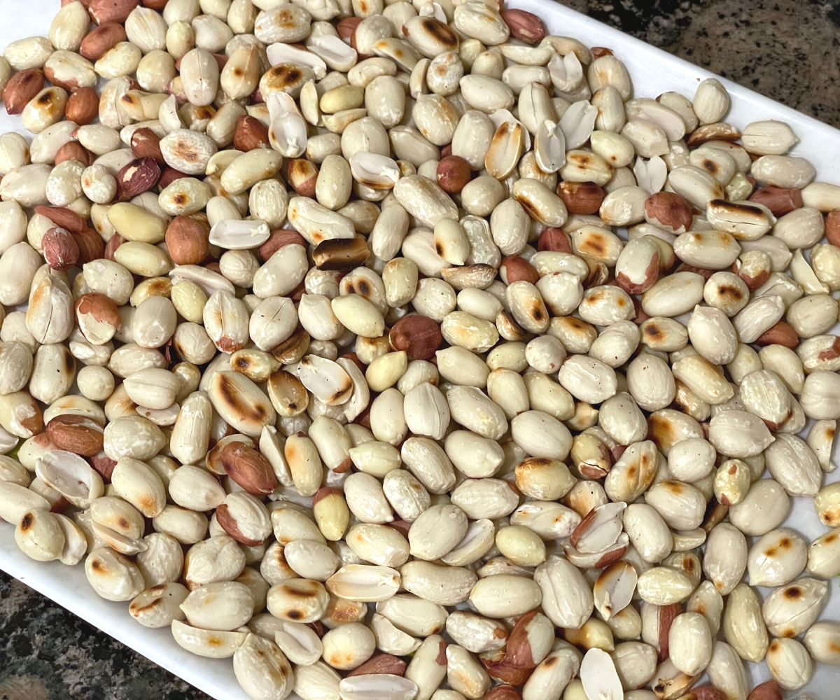 A plate is with roasted and skinned peanuts.