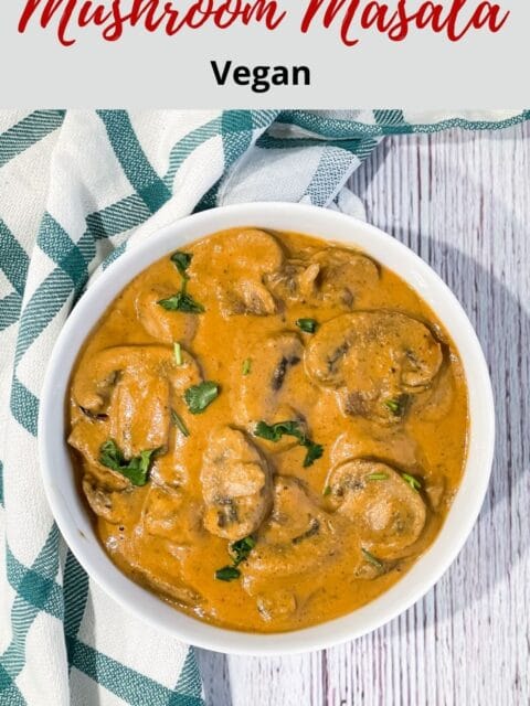 A white bowl is filled with mushroom masala