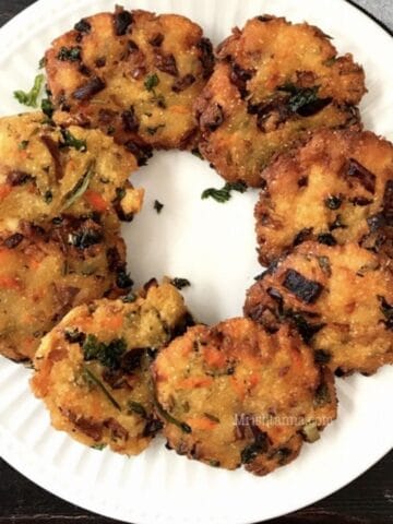 A plate of bread vada is on the table