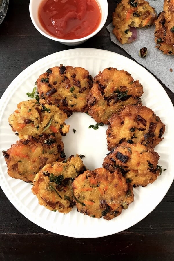 A plate of bread vada is on the table