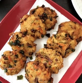 A plate of bread vada is on the table