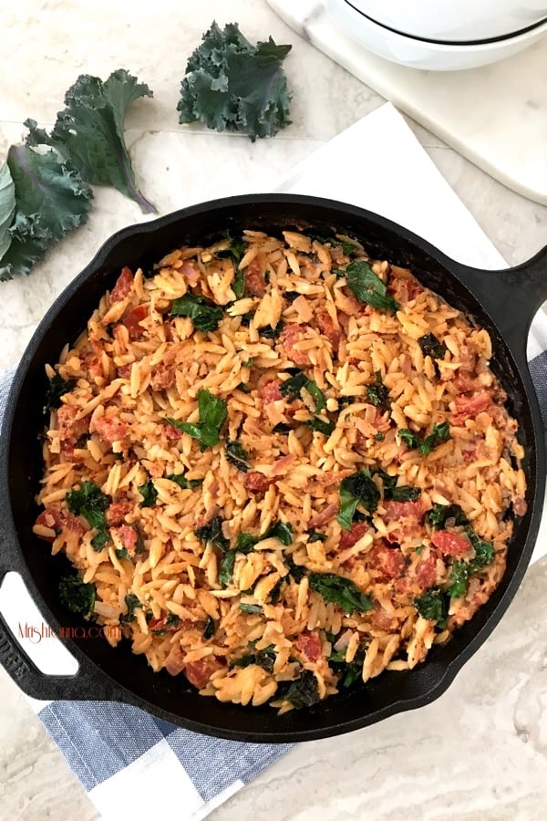 A bowl of food, with Tomato and Kale