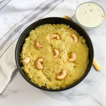 A bowl of instant pongal and coconut chutney is on the table.