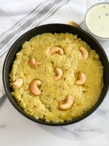 A bowl of instant pongal and coconut chutney is on the table.