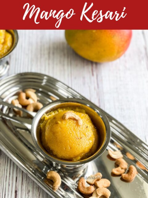 A cup of mango halwa is on the steel tray.