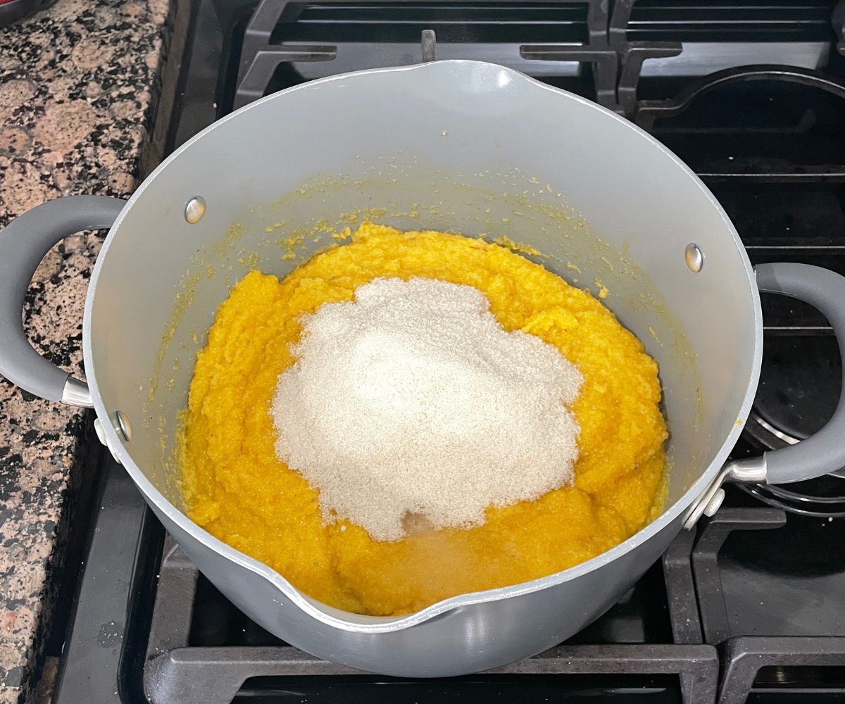 A pan is with mango sheera mixture over the heat.