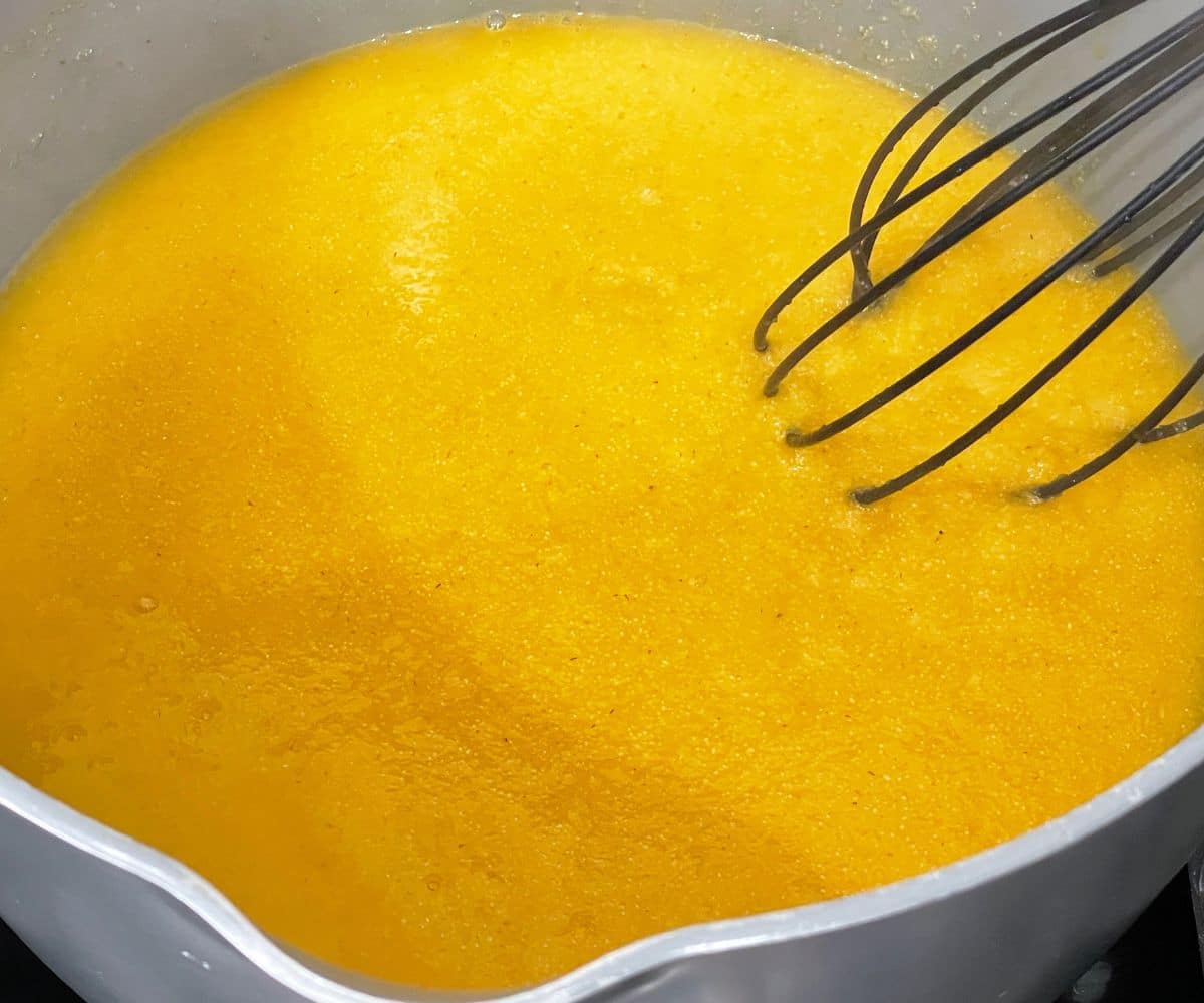 A vessel of mango halwa is on the stove top.