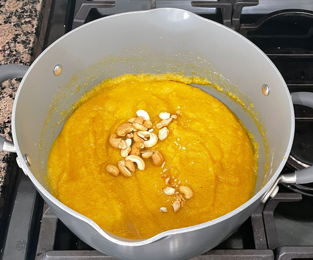 A pot of mango kesari is on the heat.