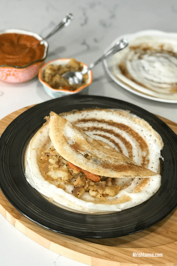 A plate of food on a table, with Dosa and Batter