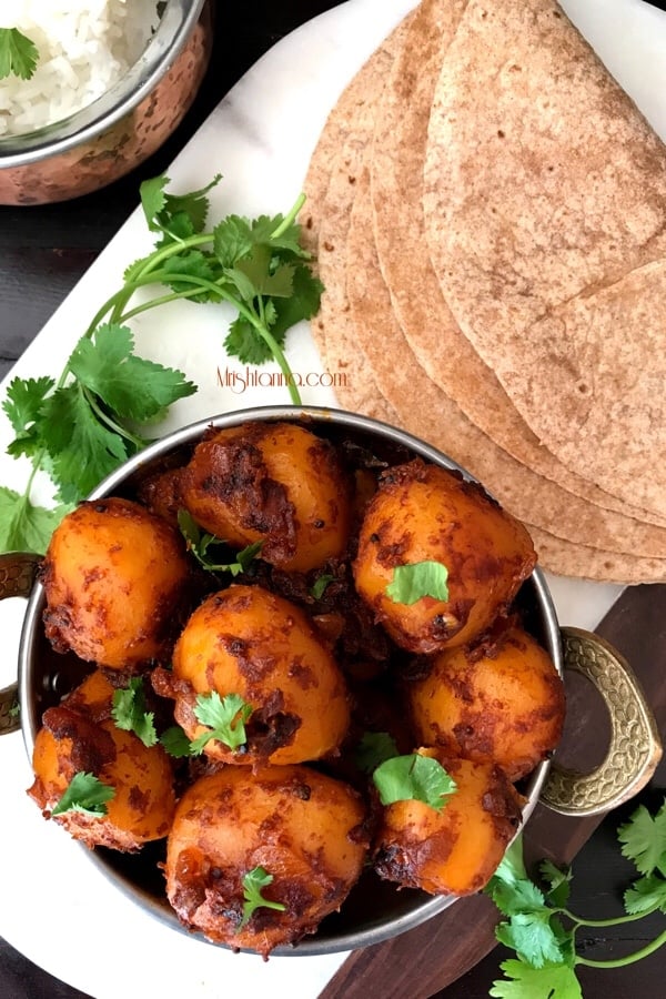 A bowl of potato masala with roti