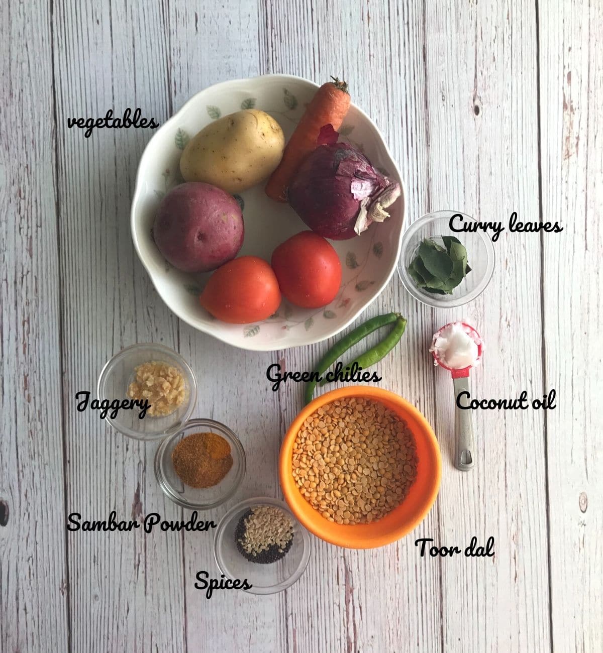 vegetables, spices are placed on the table for sambar recipe