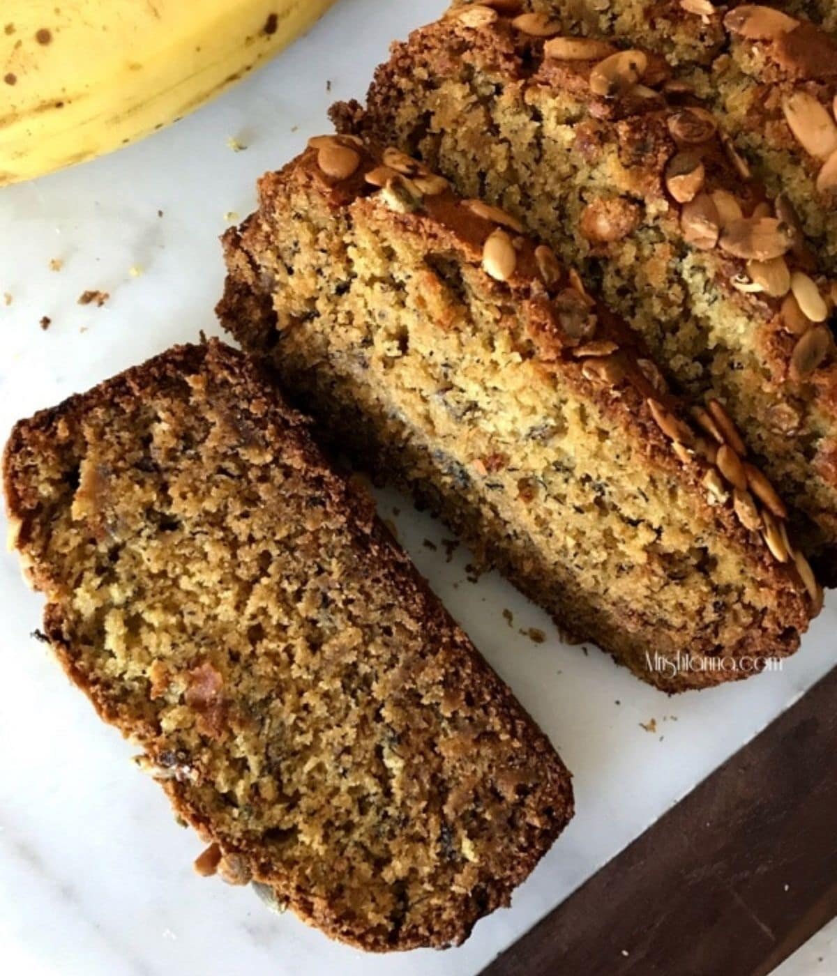 Sliced banana bread is placed on the white serving tray