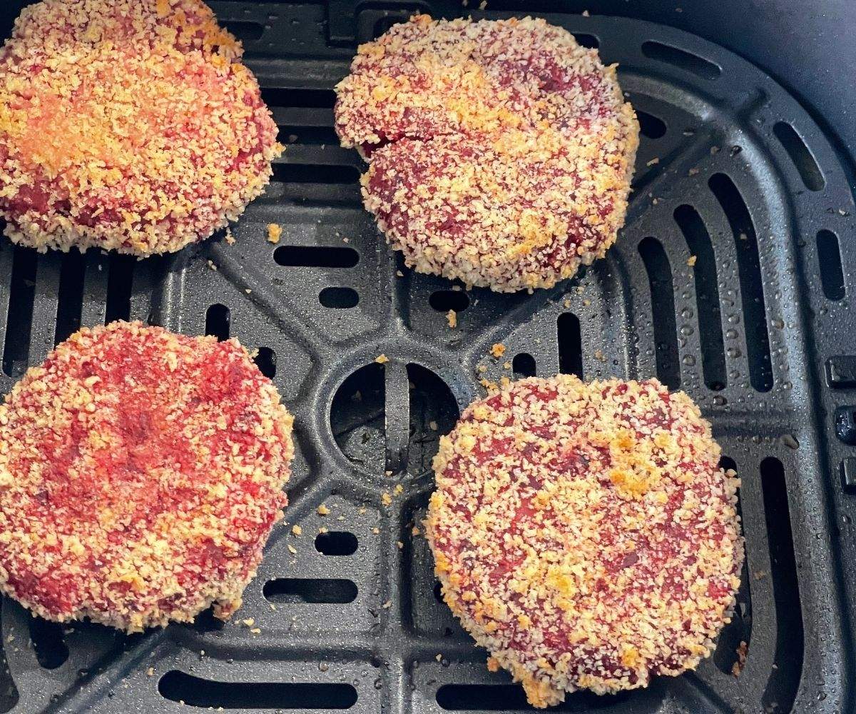 Beetroot tikki's are inside the air fryer basket.