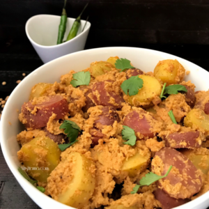 A bowl of food on a plate, with Curry