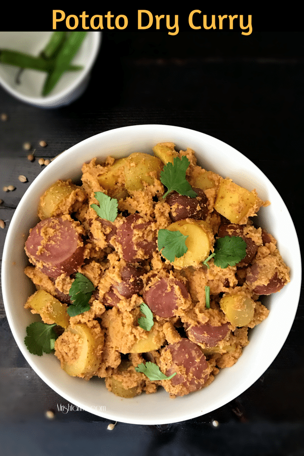 A bowl of food on a plate, with dry curry