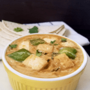 A yellow bowl filled with tofu curry and topped with cilantro