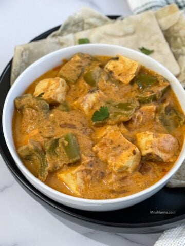 A bowl of Instant pot tofu curry is on the plate.