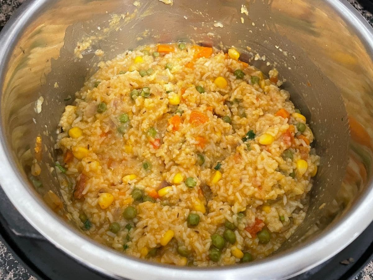 An instant pot is with khichdi on the counter top.