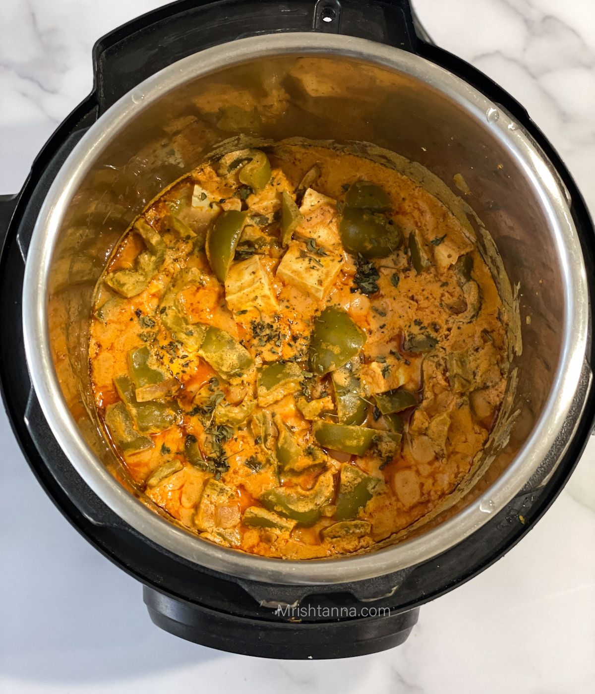 An instant pot is with Tofu curry Indian.