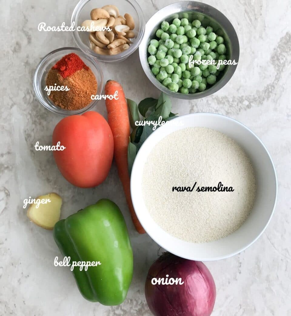 a white board is filled with masala bath ingredients like onion, capsicum, tomato, carrot, rava, and spices