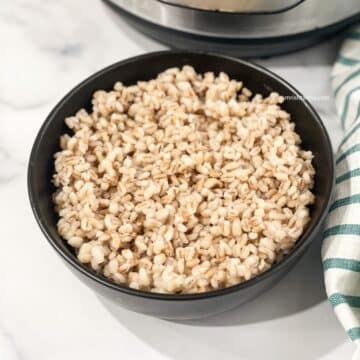 A bowl of cooked barley is on the table.