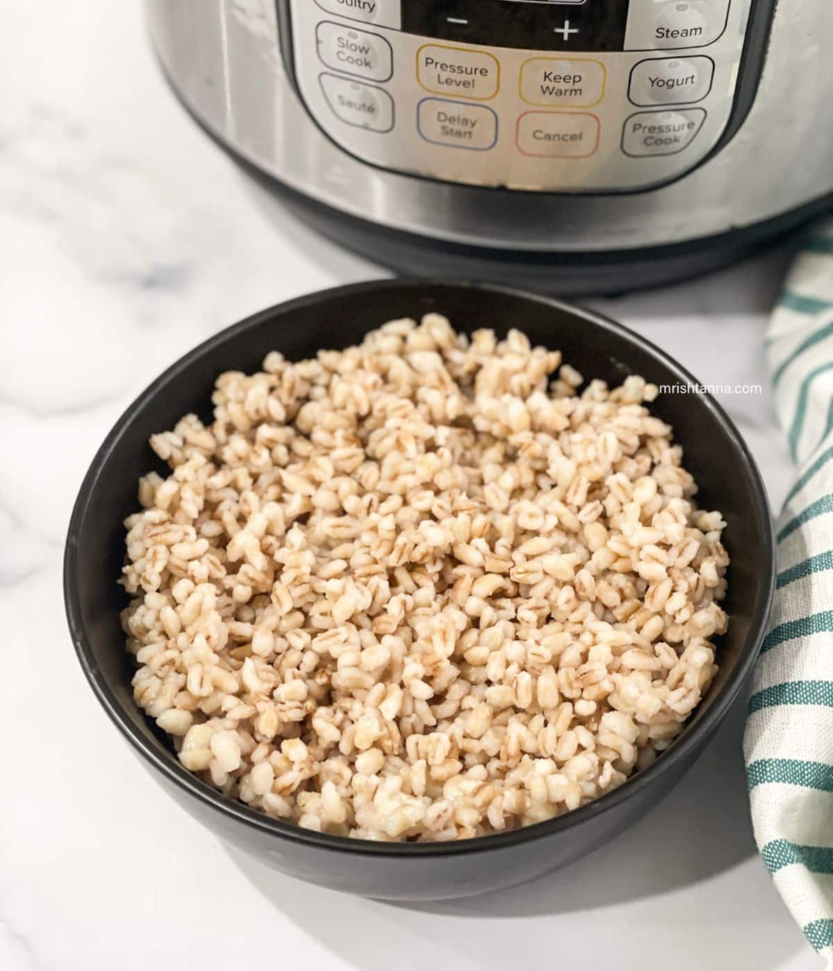 A bowl is full of cooked pearl barley.