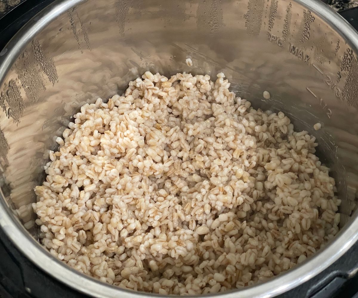 An instant pot has cooked barley.